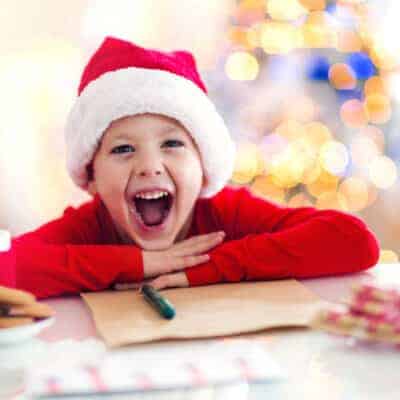 boy writing a letter to santa with free printable template.jpg